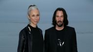 Reeves and Grant at a Saint Laurent event (Image via Getty/Phillip Faraone)